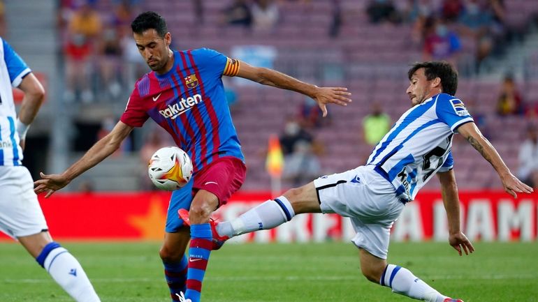 Real Sociedad's David Silva, right, fights for the ball with...