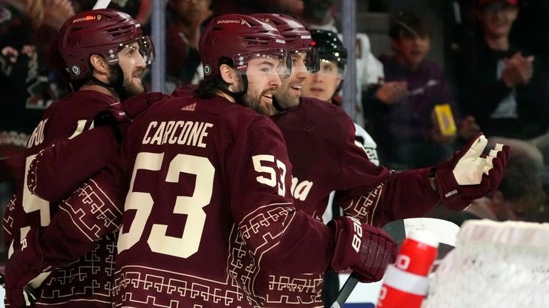 Arizona Coyotes left wing Michael Carcone (53) smiles as he...