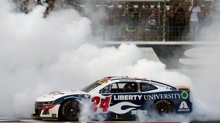 William Byron (24) burns his tires after winning the NASCAR...