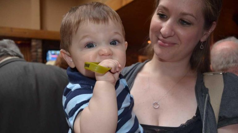 Sarah McIntyre, 30, of Waterbury, Conn., holds her 9-month-old son...