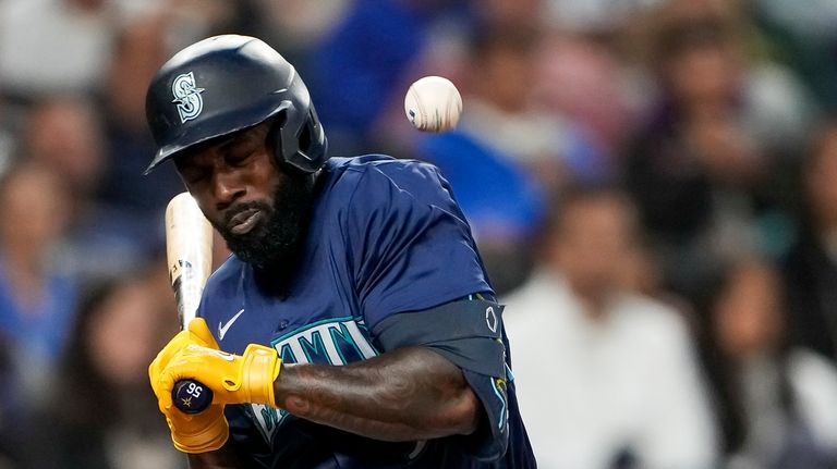 Seattle Mariners' Randy Arozarena is hit by a pitch from...