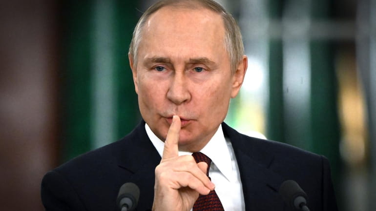 Russian President Vladimir Putin gestures while speaking at a news...