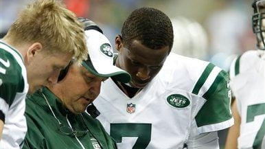 Geno Smith and Matt Simms talk with offensive coordinator Marty...