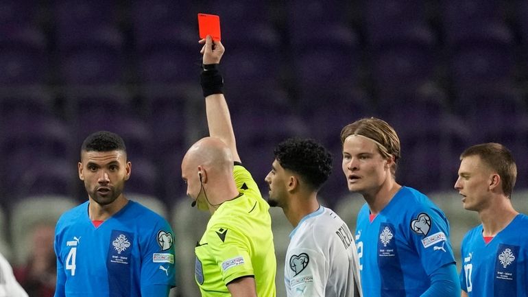 Israel's Roy Revivo receives a red card by referee Anthony...