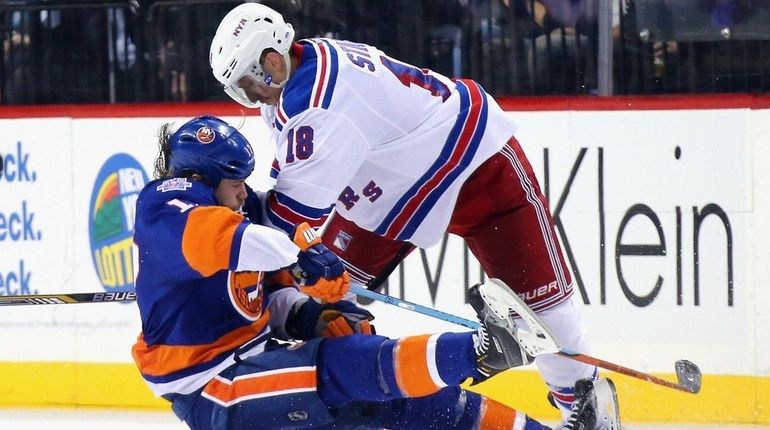 Marc Staal #18 of the New York Rangers checks Matt...