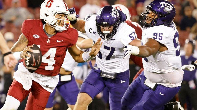 Stanford quarterback Ashton Daniels (14) scrambles and completes a pass...