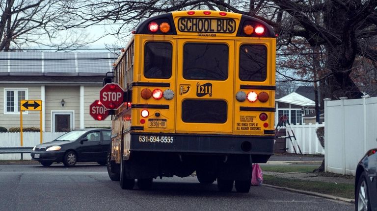 A school bus picking up students on Nathalie Avenue in Amityville...