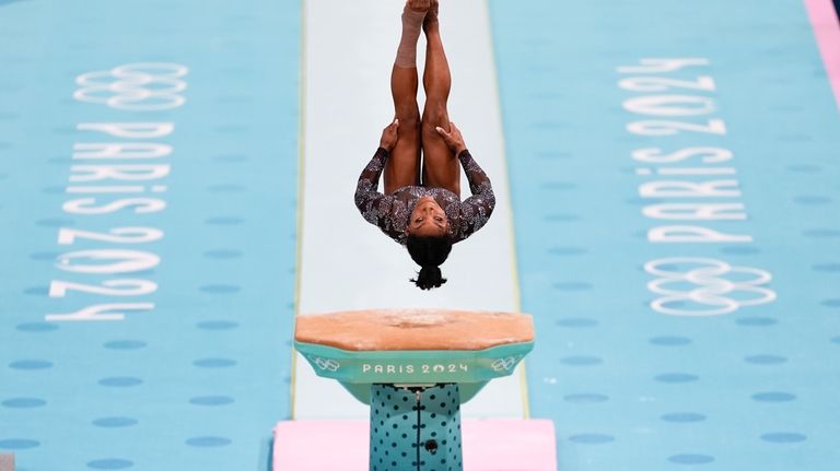 Simone Biles, of United States, competes on the vault during...