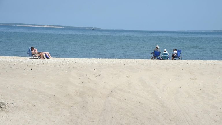 People relax on beach at the foot of Bay Street...