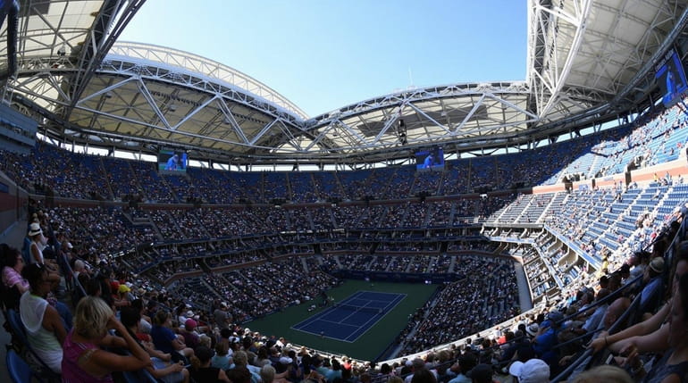 A view of Arthur Ashe Stadium with the roof open...