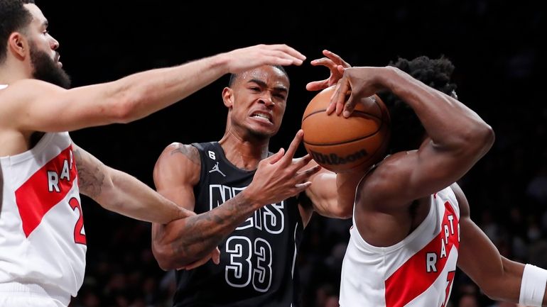 Brooklyn Nets forward Nic Claxton (33) works against Toronto Raptors'...