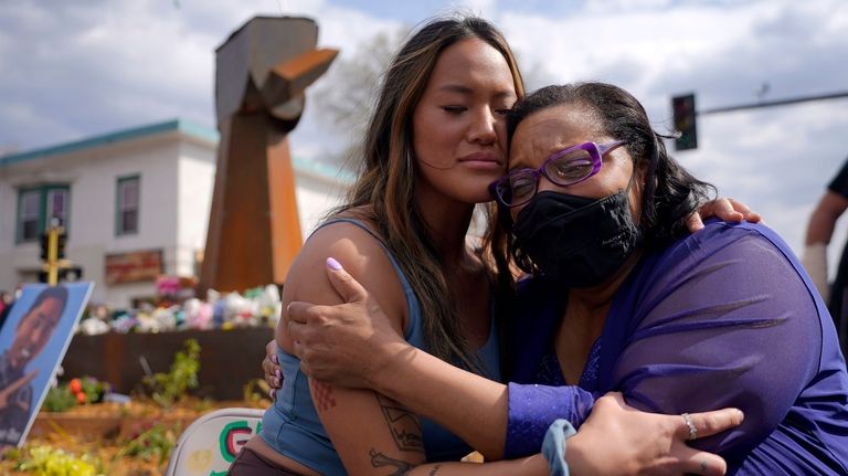 Community organizer Anthea Yur Kokoro, left, hugs Del Shea Perry,...