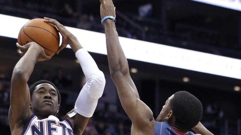 New Jersey Nets' MarShon Brooks shoots against Charlotte Bobcats' Cory...