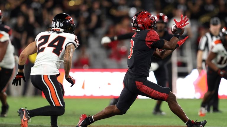 San Diego State wide receiver Ja'Shaun Poke, right, catches the...