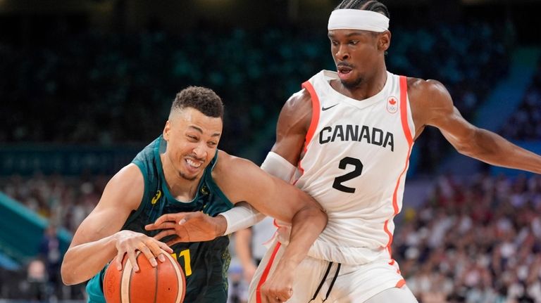 Australia's Dante Exum, left, tries to get by Canada's Shai...