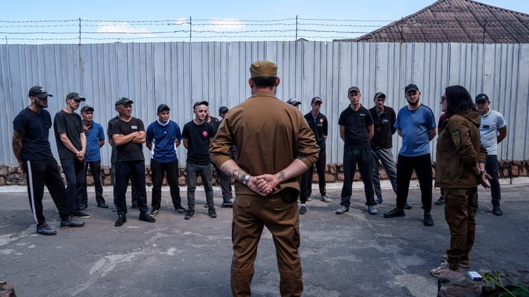 Prisoners listen to a Ukrainian sergeant of the Battalion Arey...