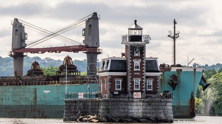 A ship passes the Hudson Athens Lighthouse, Wednesday, June 12,...