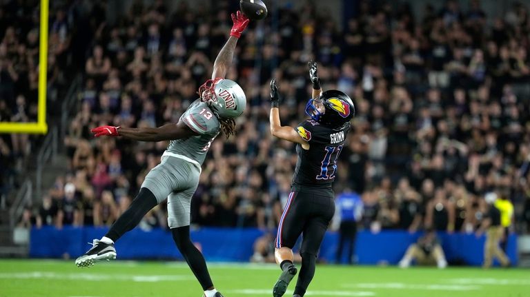 UNLV defensive back Jarvis Ware, left, tips the ball away...