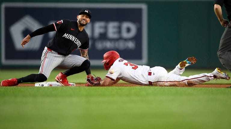 Washington Nationals' Jacob Young, right, steals second against Minnesota Twins...
