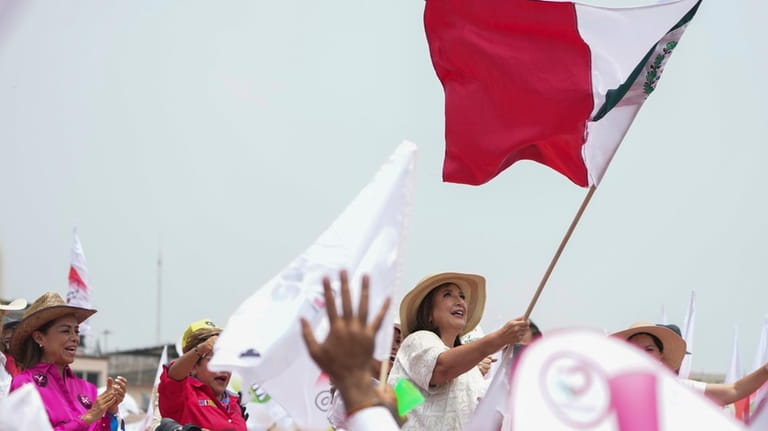 Presidential candidate Xochitl Galvez waves a Mexican flag at her...