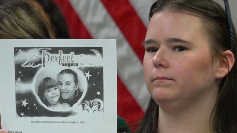 Nicolette Brainard-Barnes holds a photo of her mom Maureen Brainard-Barnes...