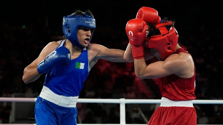 Thailand's Janjaem Suwannapheng, right, fights Algeria's Imane Khelif in their...