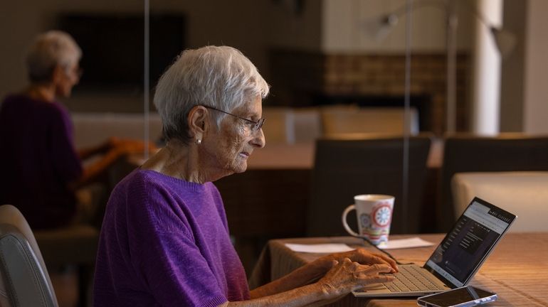 Barbara Winston uses a computer at her home in Northbrook,...