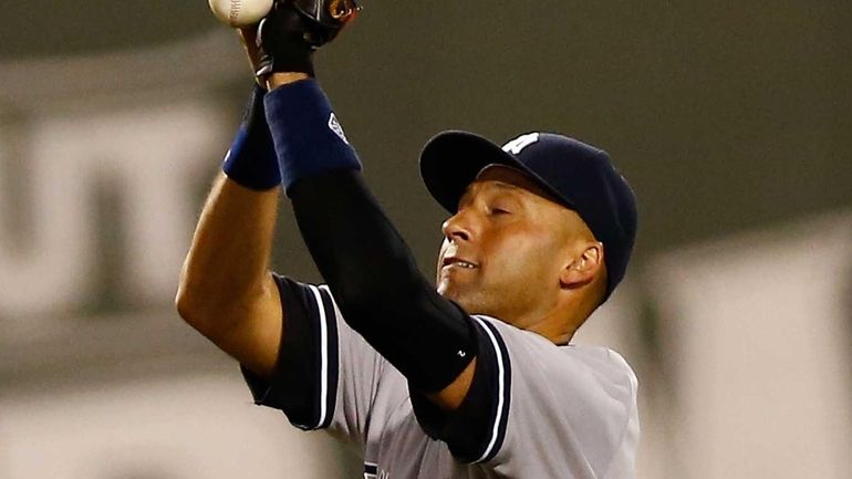 Derek Jeter drops a routine infield fly ball hit by...