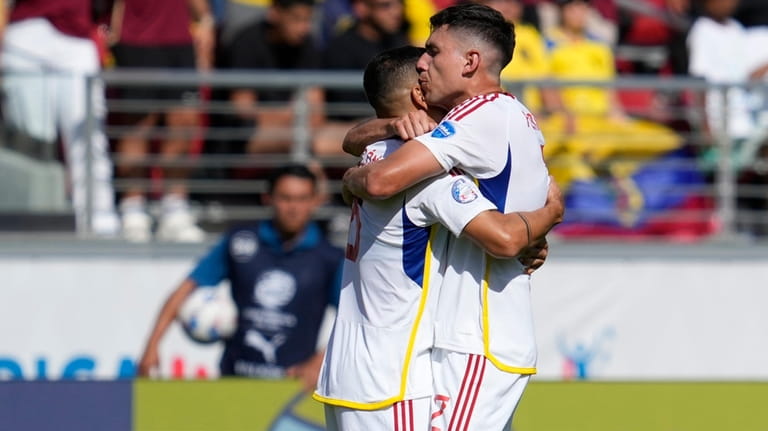 Venezuela's Nahuel Ferraresi, rigth, and Tomas Rincon celebrate after beating...