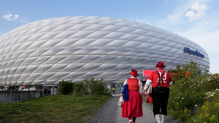 Bayern Munich fans arrive to the Allianz Arena prior to...