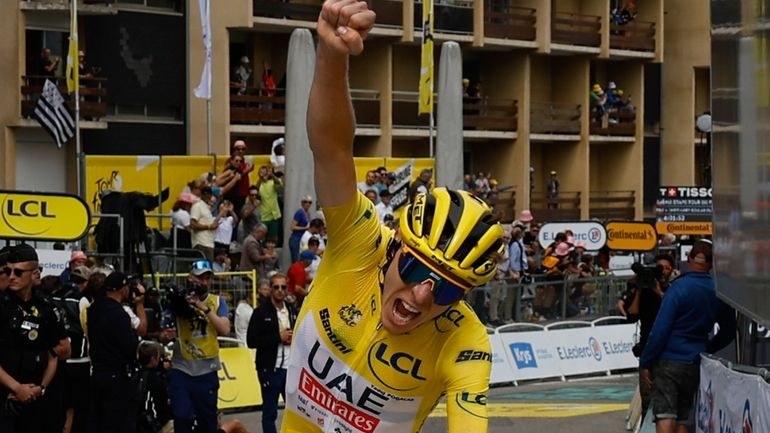 Stage winner Slovenia's Tadej Pogacar, wearing the overall leader's yellow...