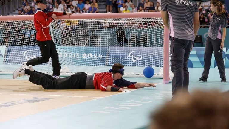 Calahan Young from the U.S. dives for a ball during...