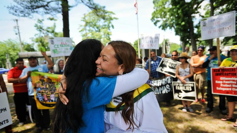 Denisse Giron, of Uniondale, left, and Marcy Suarez, right, of...