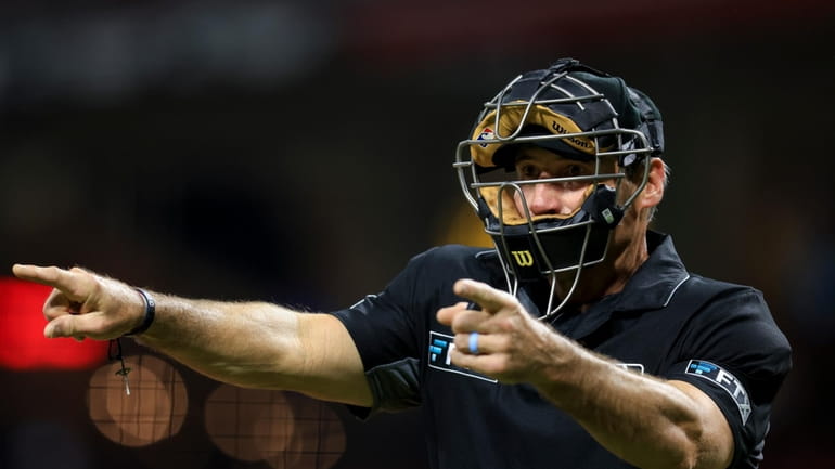 MLB umpire Angel Hernandez signals during a baseball game between...