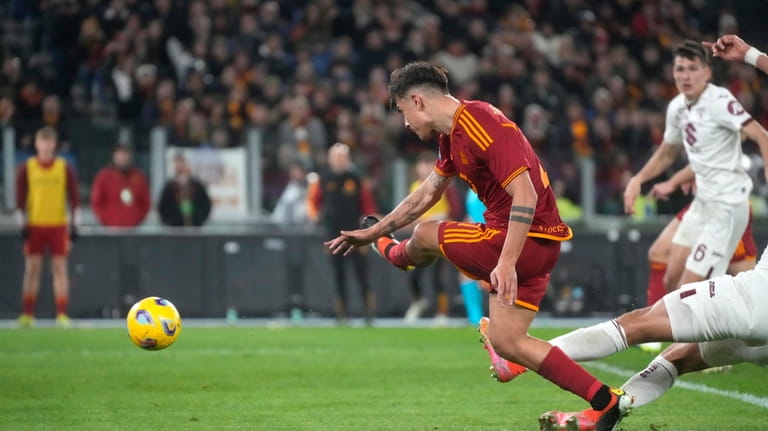 Roma's Paulo Dybala scores his side's third goal during the...