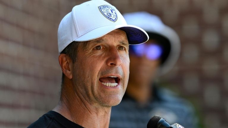 Baltimore Ravens head coach John Harbaugh talks to the media...