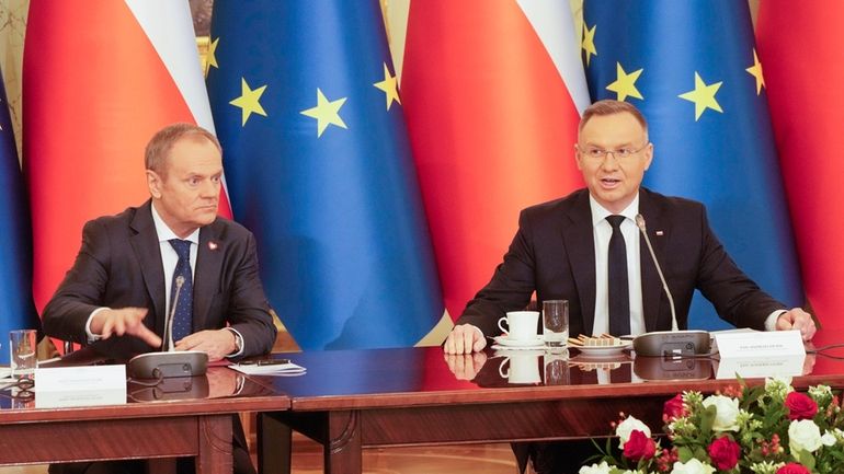 Poland's Prime Minister Donald Tusk, left, and President Andrzej Duda...