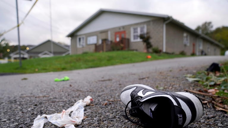 Debris, mixed with personal items including shoes, are scattered after...