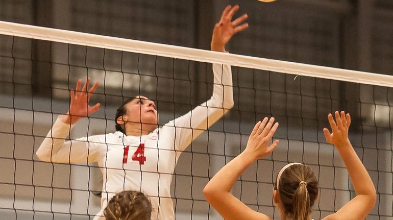 Connetquot's Kiarra Roth goes for the kill as Commack's Samantha...