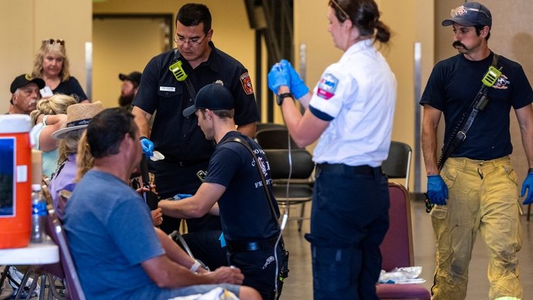 Members of the Colorado Springs Fire Department and AMR paramedics...