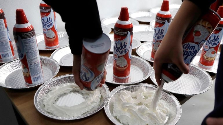 Students prepare whipped cream pies at the Hamtramck Academy March...