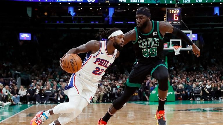 Philadelphia 76ers' Patrick Beverley (22) drives past Boston Celtics' Neemias...