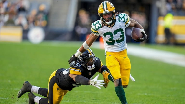 Green Bay Packers' Aaron Jones is stopped by Pittsburgh Steelers'...