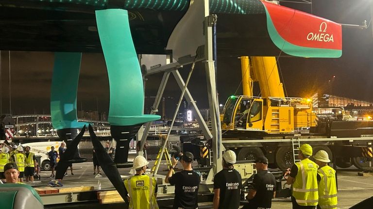 Emirates Team New Zealand inspects the team’s America’s Cup boat...