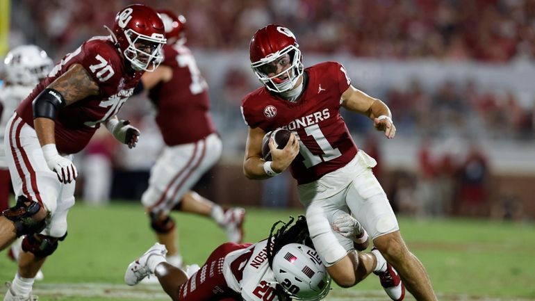 Oklahoma quarterback Jackson Arnold (11) runs for a fist down...