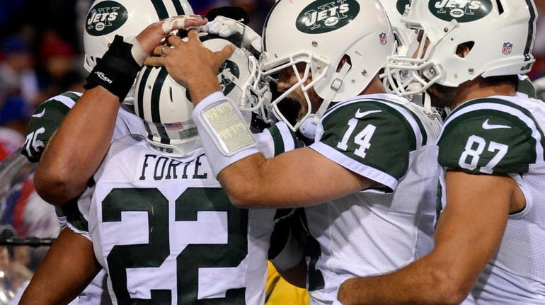 Jets running back Matt Forte celebrates his touchdown with Ryan...