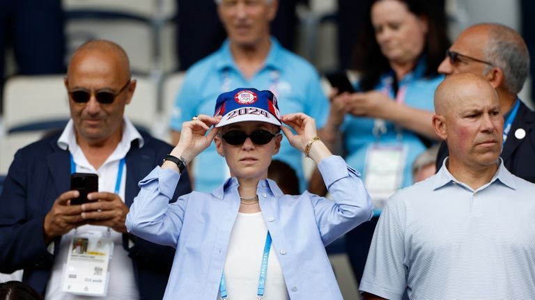 For US soccer player Megan Rapinoe adjusts her cap as...