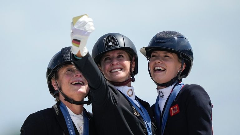 Medalists from left to right, Germany's Isabell Werth, Jessica von...