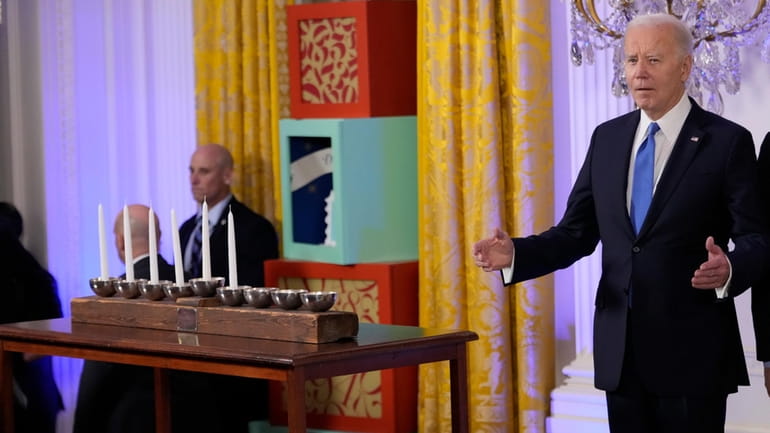 President Joe Biden arrives to speak at a Hanukkah reception...