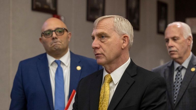 Richard Donoghue (center), a former U.S. Deputy Attorney General, has been...